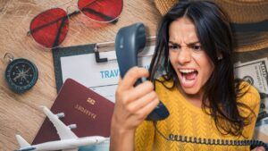 Lady staring at a phone, seemingly frustrated, with travel props scattered about the background